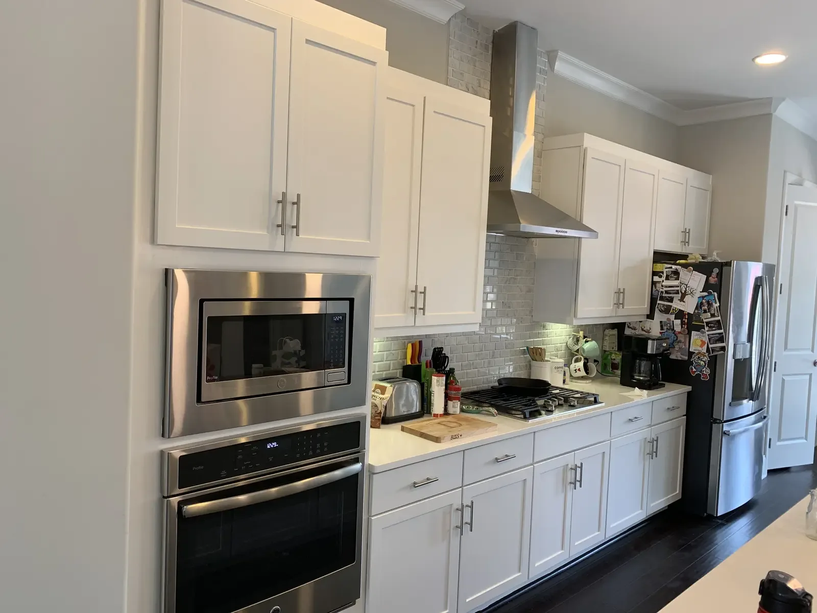 Finished white cabinet refinishing project around a range
